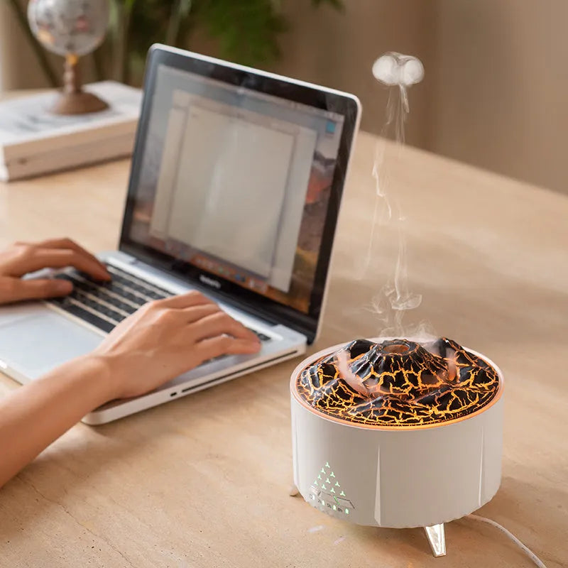 White mini simulated flame ultrasonic aromatherapy humidifier on wooden surface with remote control