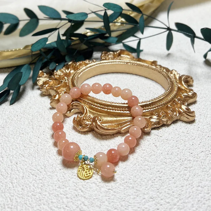Pink natural stone set on a simple alloy chain bracelet for women.