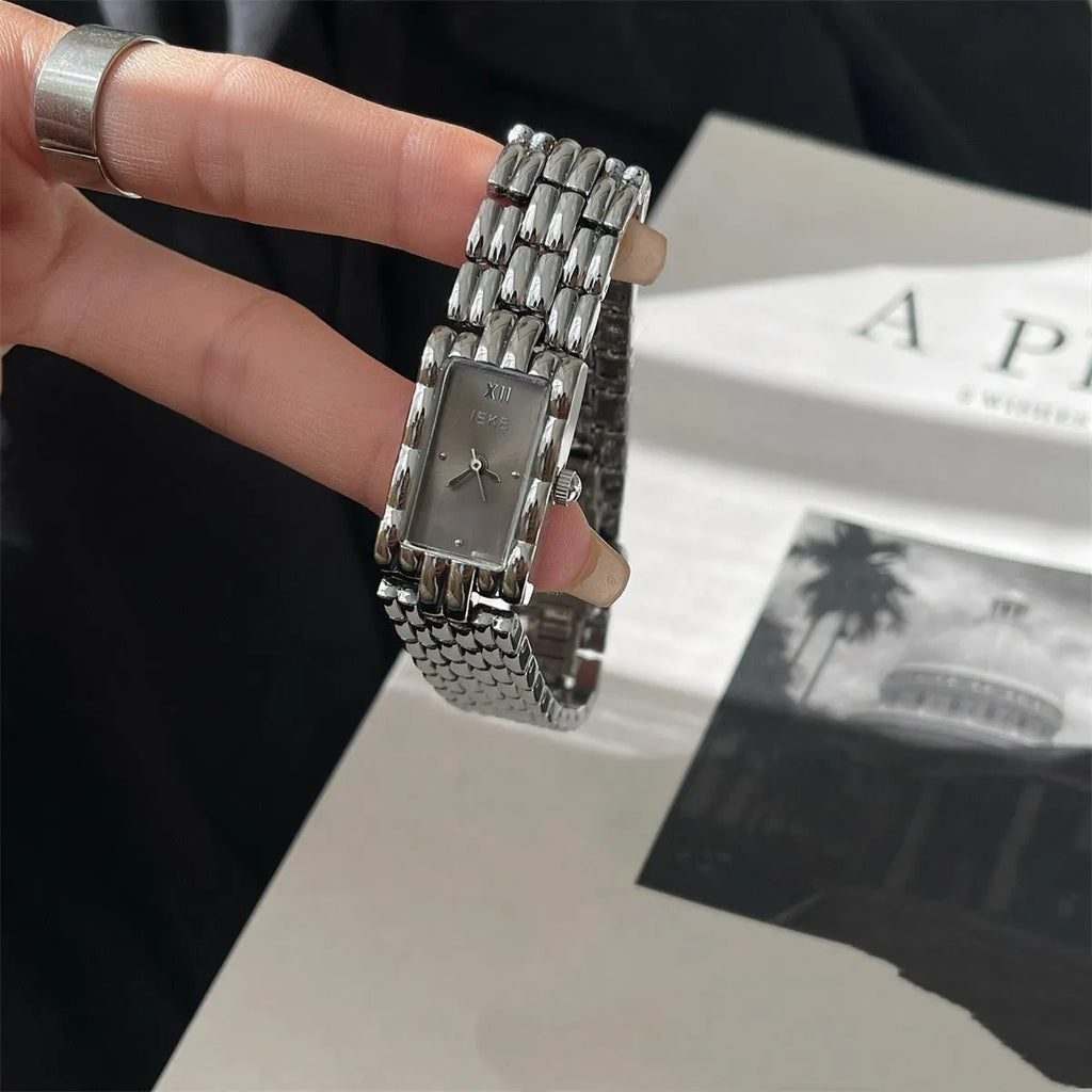 Women's mid-ancient bracelet watch with a 15mm silver dial and stainless steel strap.