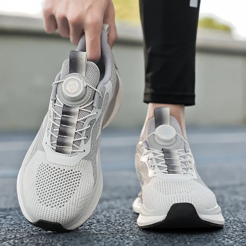 Men's beige Korean style running shoes with rotating button closure on a grey background.