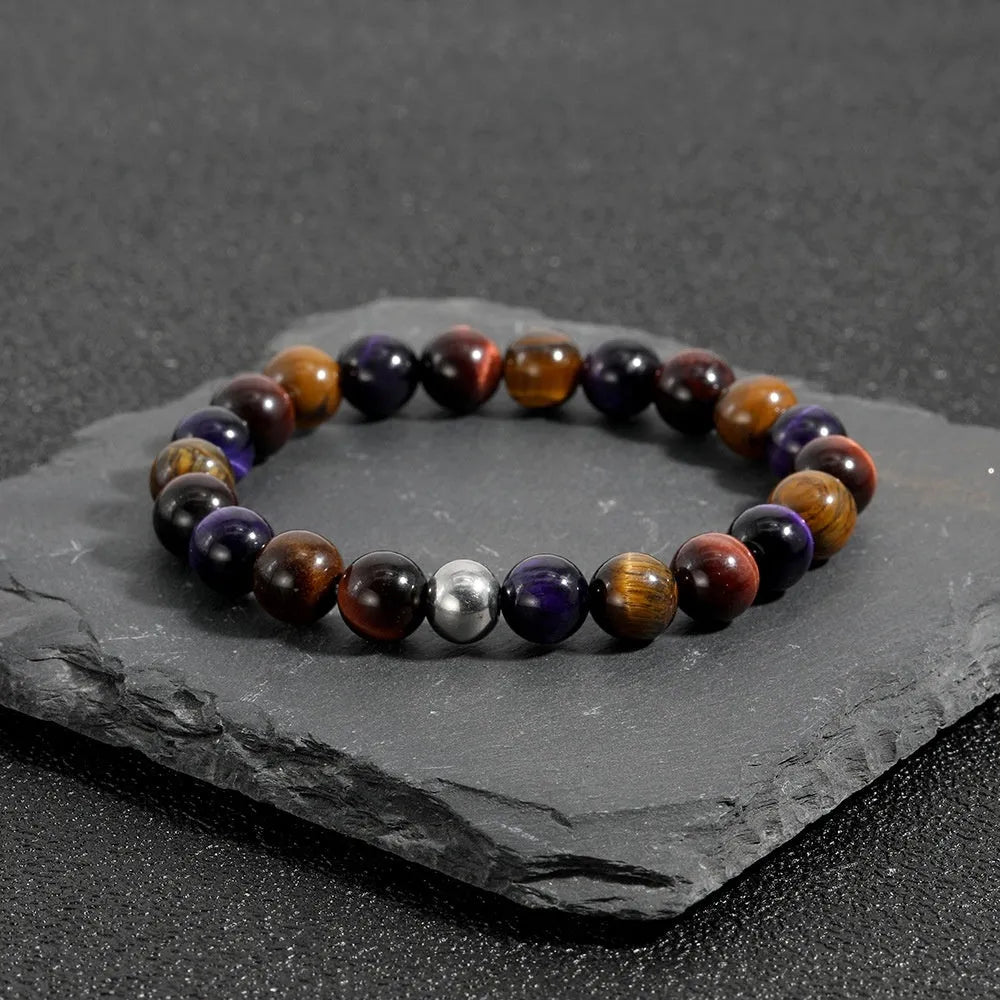 Minimalist elastic bracelet with a geometric natural tiger-eye stone in yellow, purple, or red.