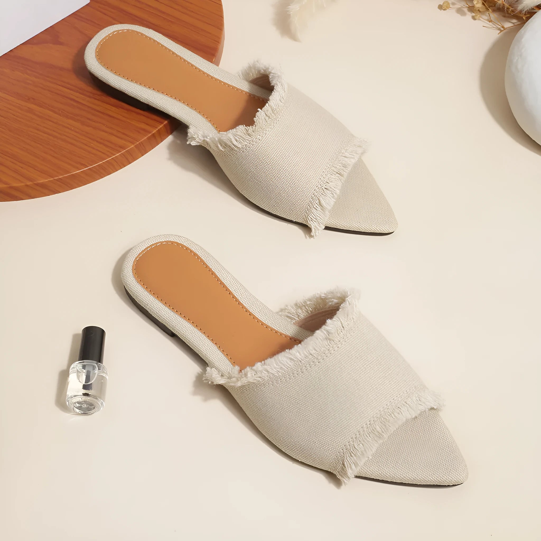Women's denim flat slippers with tassel detail in multiple colours showing leather lining and PVC sole