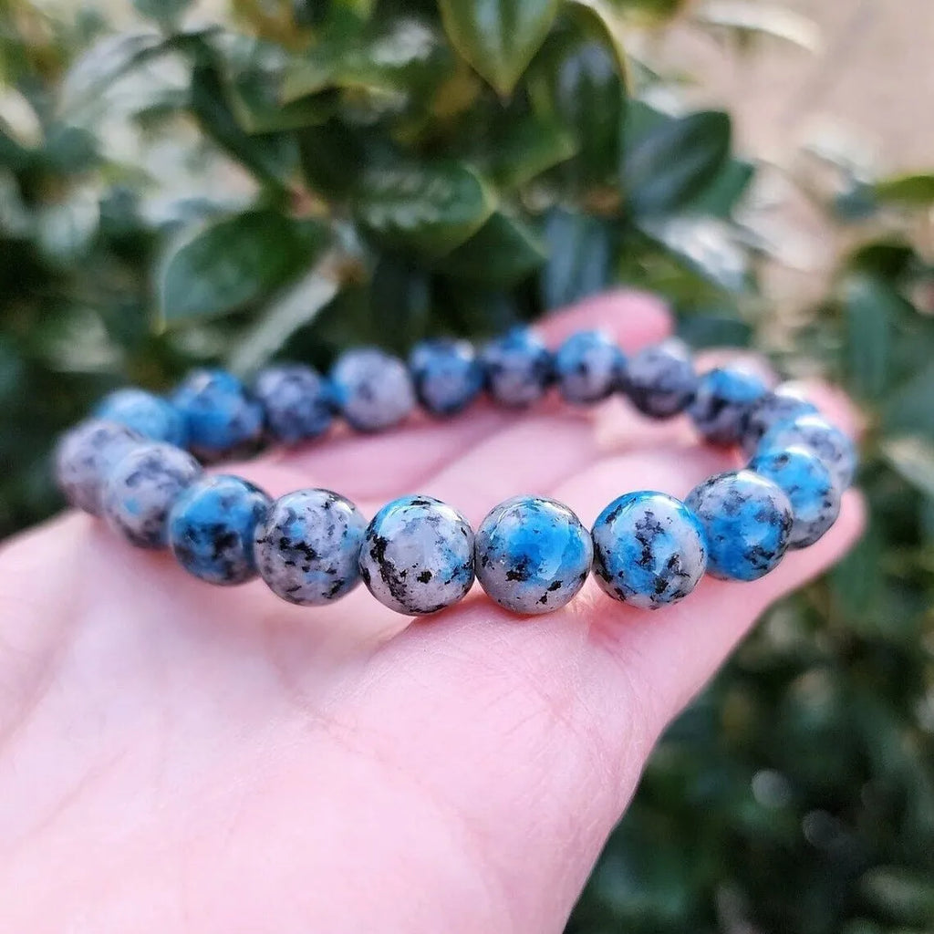 Handmade geometric bracelet made from blue K2 Azurite stone beads on a wrist.