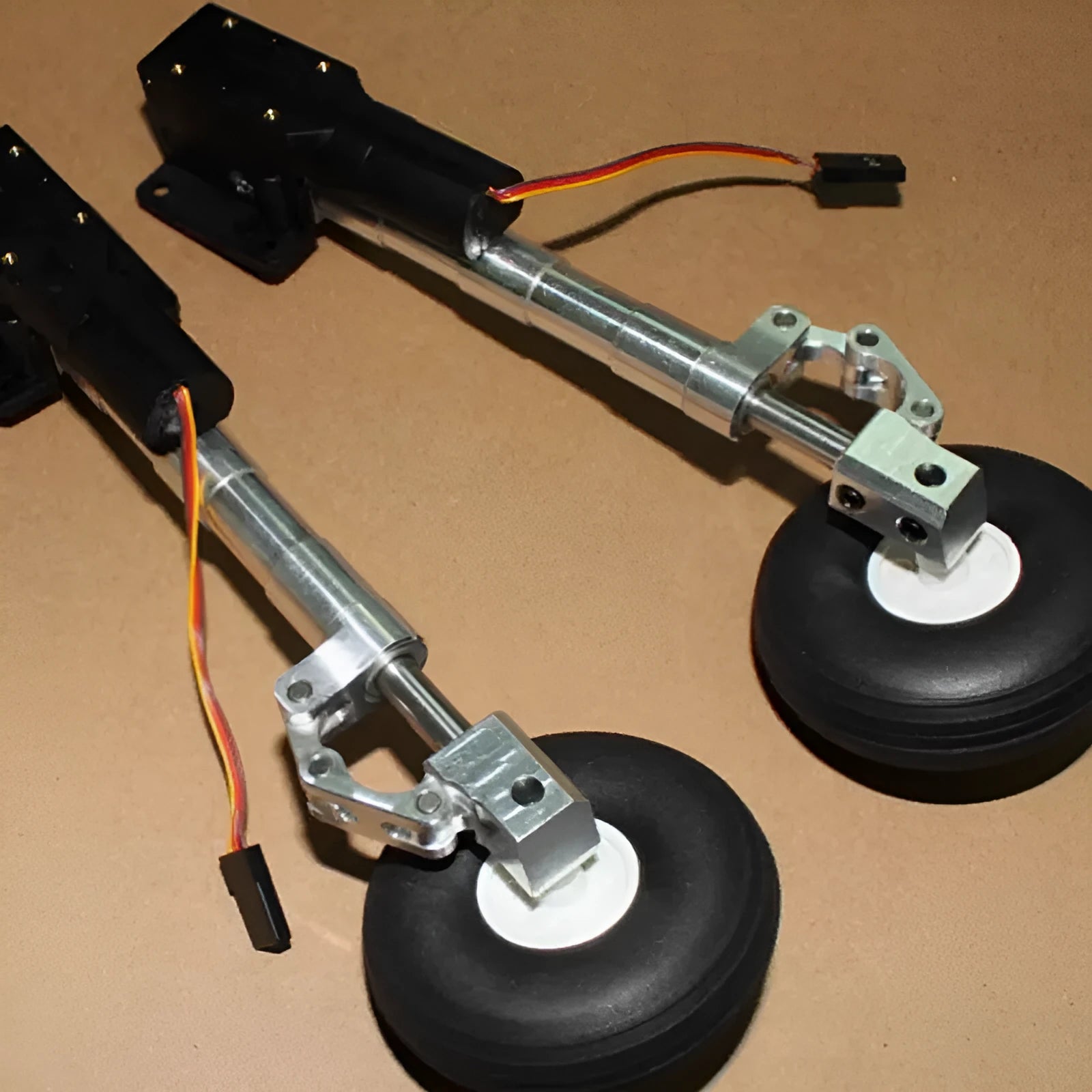Alloy retractable shock-absorbing landing gear for toy aircraft with multiple height and wheel options