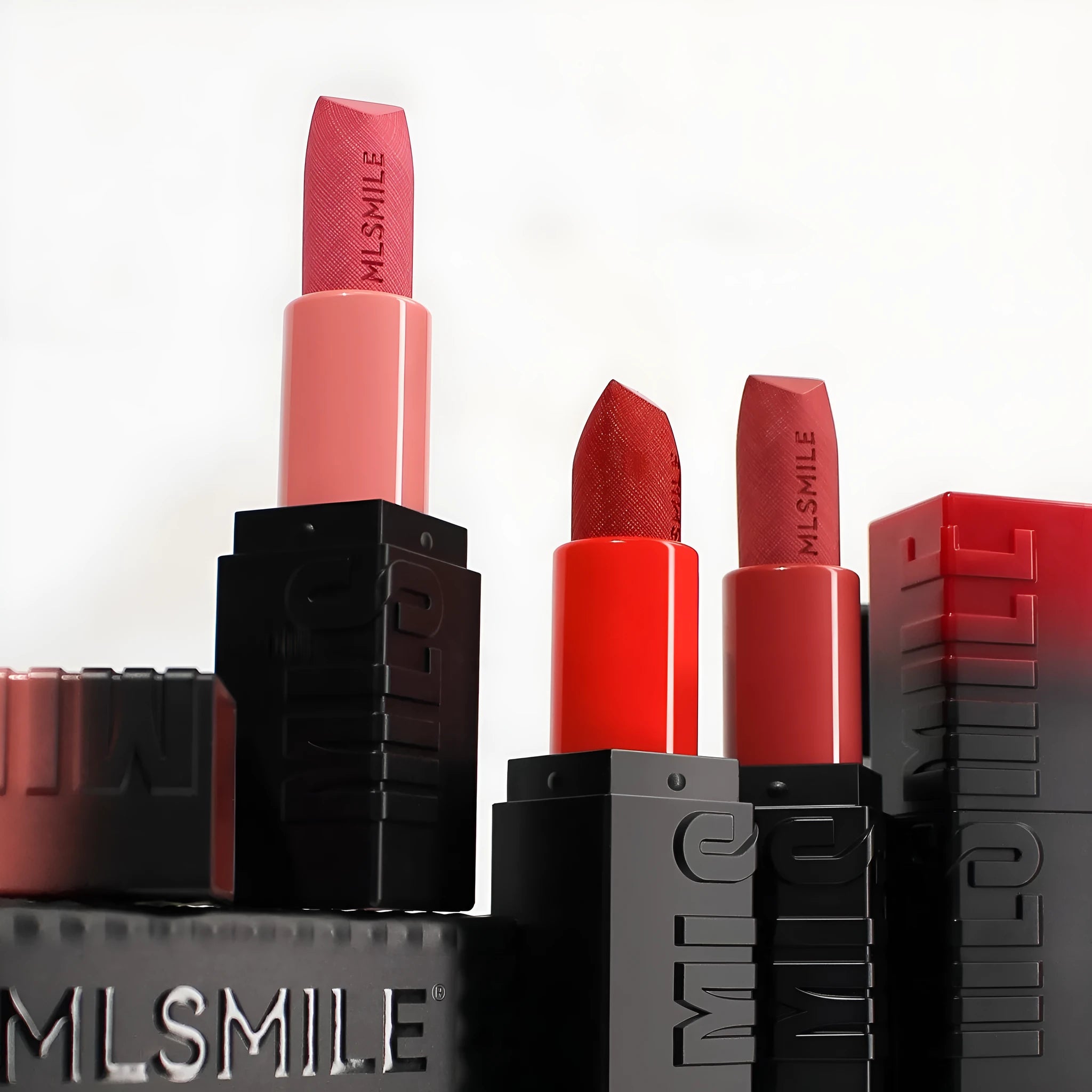 MLSMILE three embossed lipsticks in rose gold cases with decorative design
