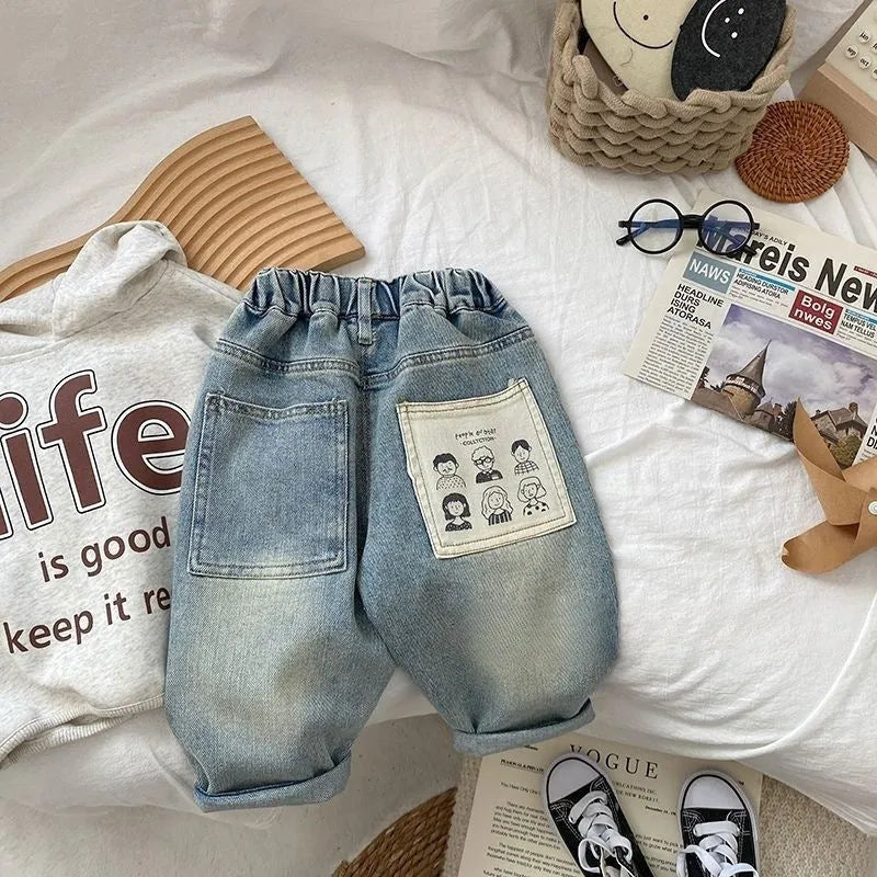 Light-coloured boys denim jeans with printed back pocket and elastic waist, front view