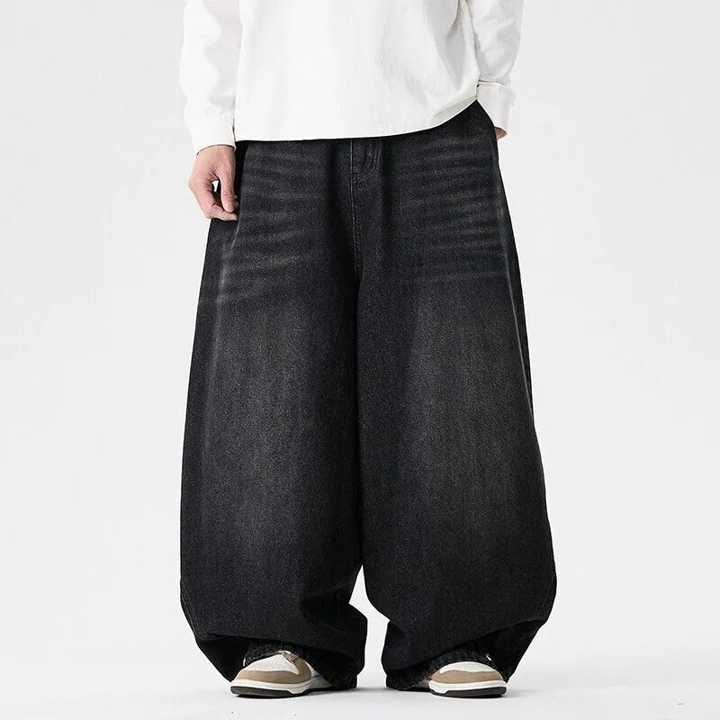 Man wearing light blue baggy fit denim jeans with a straight leg and low waist.
