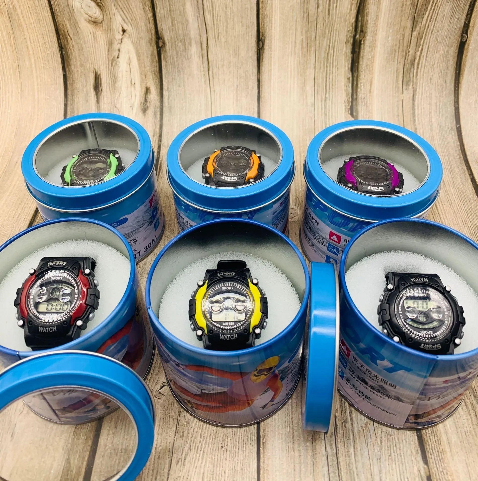 Children's digital sports watch with silicone strap and plastic case showing multiple functions including alarm and countdown timer