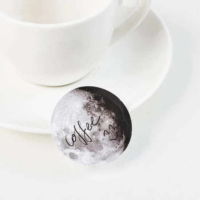 Boxed sheet of 45 black moon phase and calendar planet stickers on self-adhesive paper.