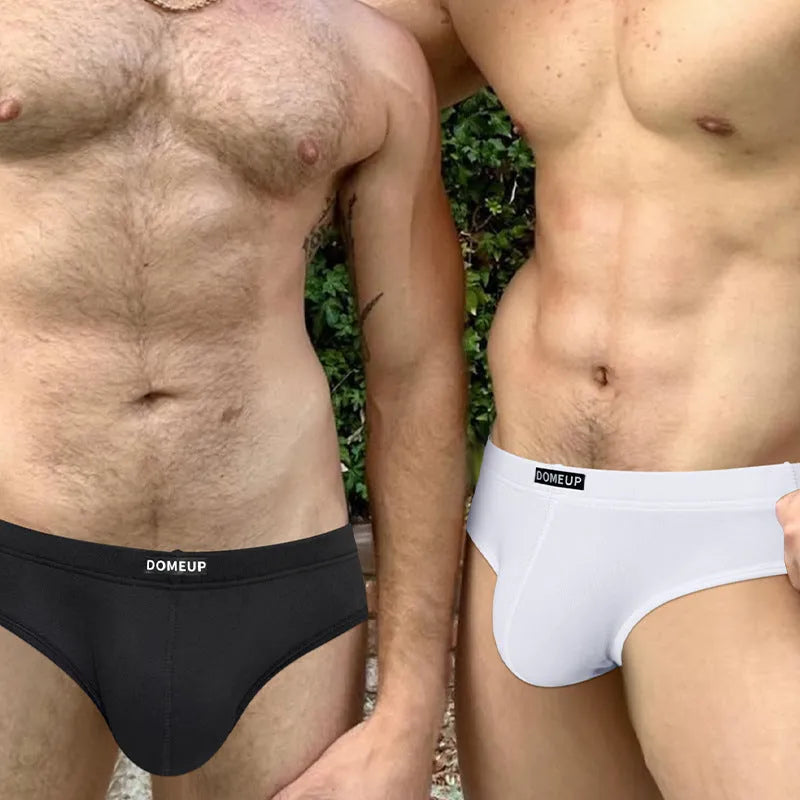 Men's solid colour seamless briefs in black, shown flat, highlighting low waist and knit fabric.