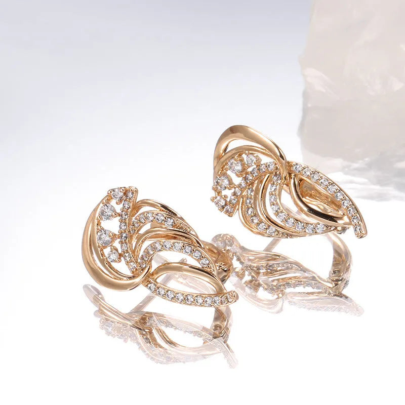 Gold-plated copper ear clips with geometric wing design and micro-inlaid zircon gemstones