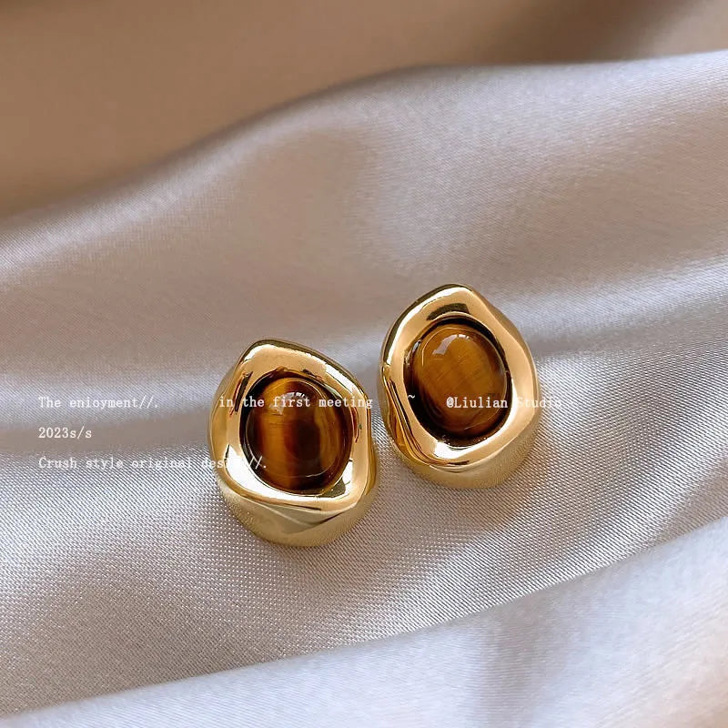 Three pairs of handmade geometric earrings with electroplated alloy construction and tassel detailing