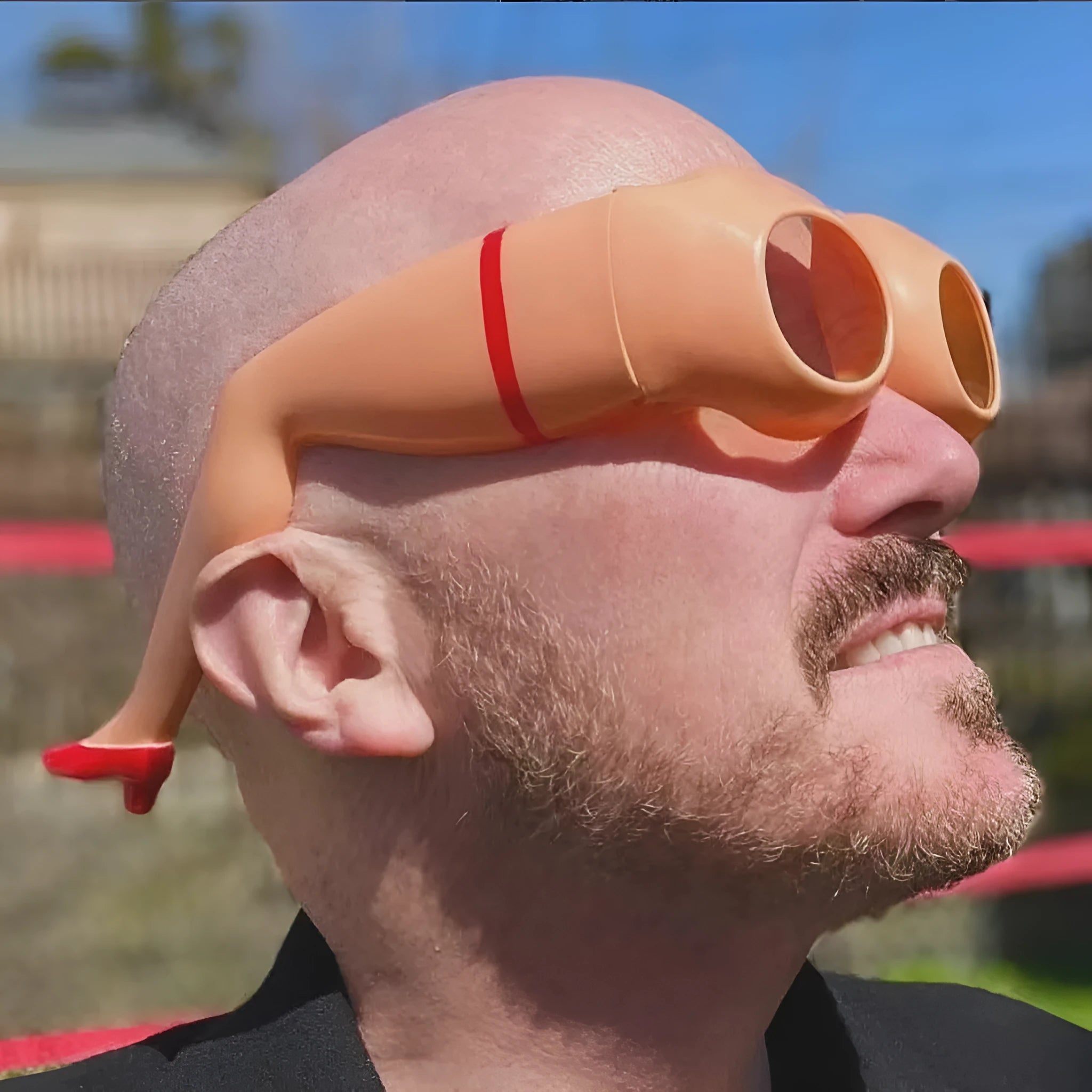Orange plastic sunglasses with a unique leg and hip personality design.