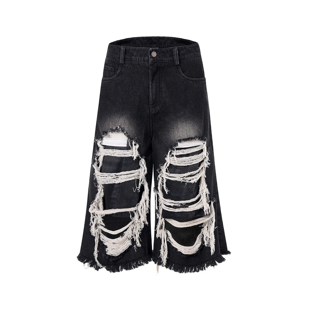 Black women's cropped wide-leg jeans with ripped patch details on the legs.