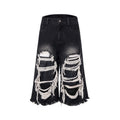 Black women's cropped wide-leg jeans with ripped patch details on the legs.