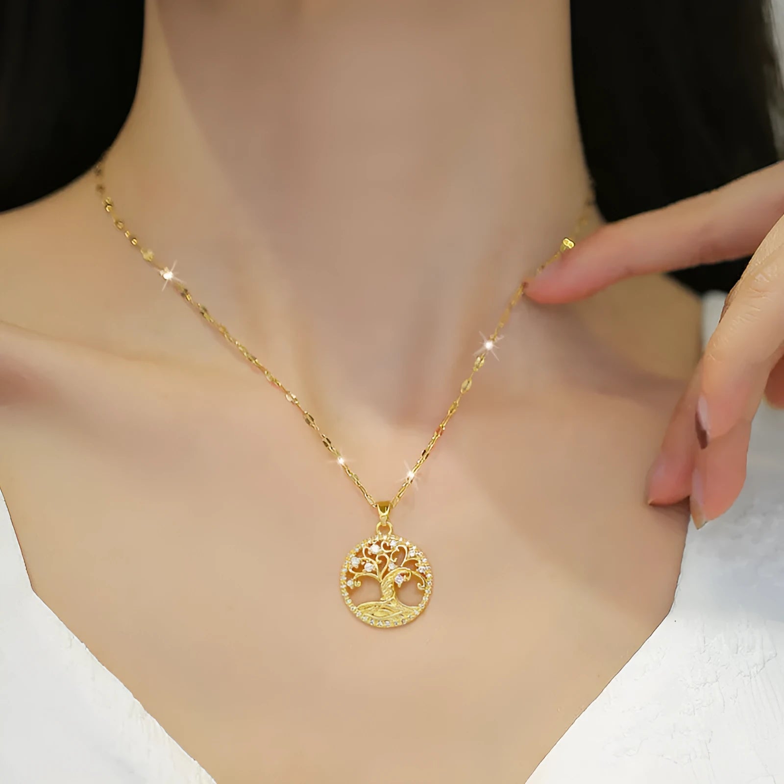 Gold-plated cross necklace with a mother pearl pendant, detailed rhinestones, and an adjustable lip chain.