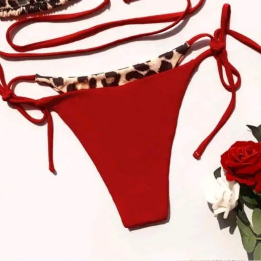 Women's red leopard print halter neck bikini with lace-up front on mannequin