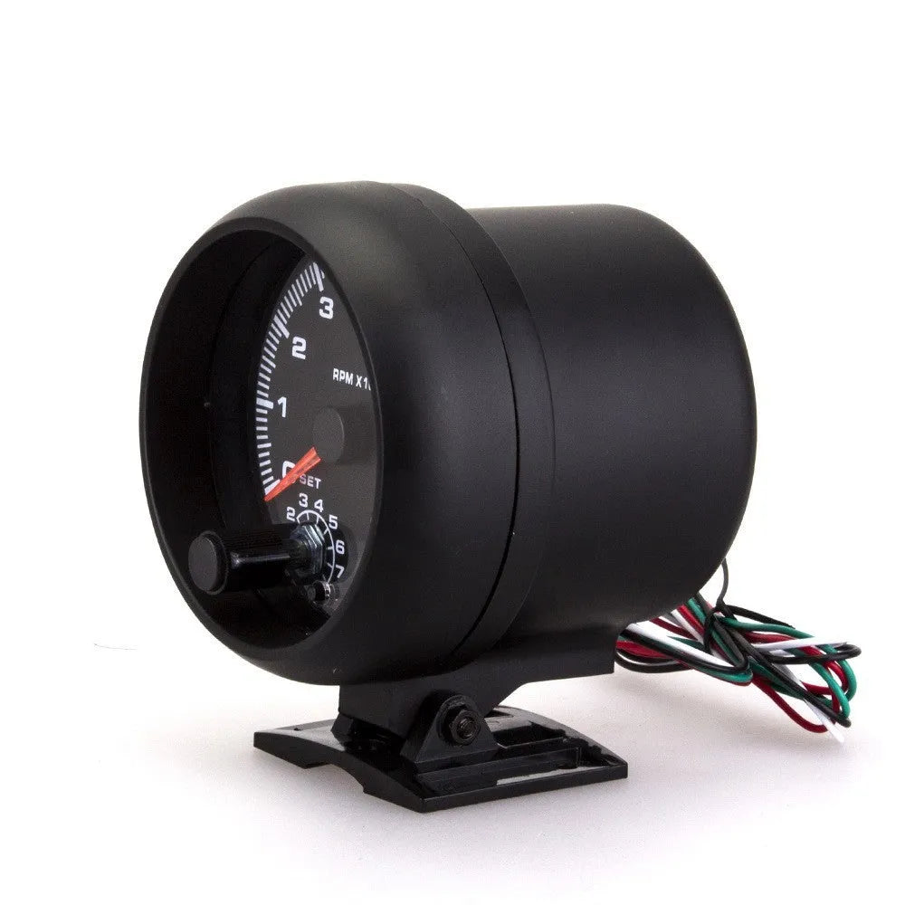 Black plastic automotive tachometer with blue light pointer display showing rpm scale