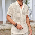 Men's solid colour short sleeve lapel shirt in cotton blend fabric on a hanger.