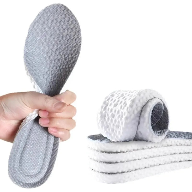Pair of grey PU foam sports insoles on a white background, showing trimmable edges.