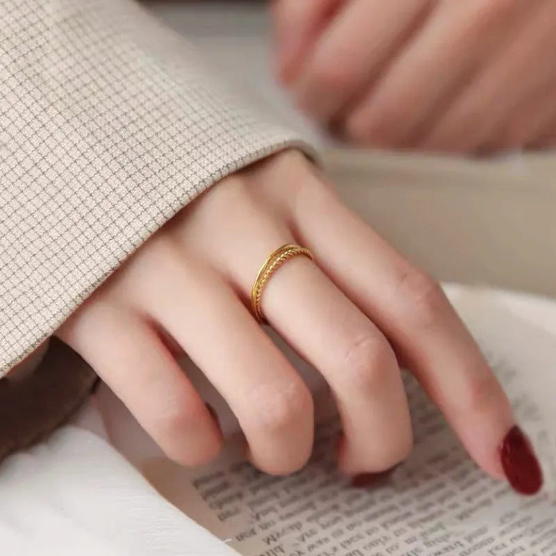 Women's simple bracelet style brass gold plated ring shown in twist, matte and glossy finish variations.