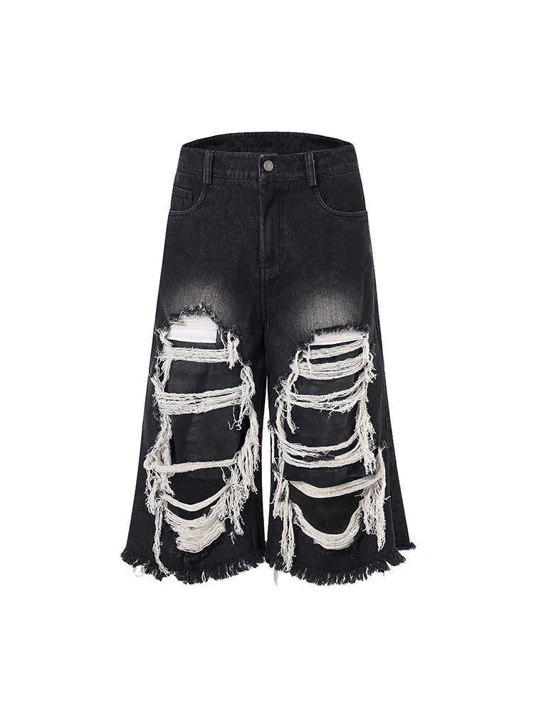 Black women's cropped wide-leg jeans with ripped patch details on the legs.