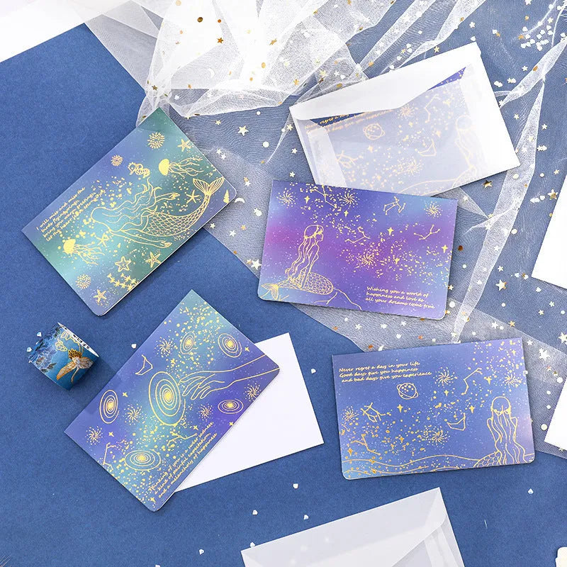 Three decorative paper envelopes with bronzing mermaid design in assorted colours