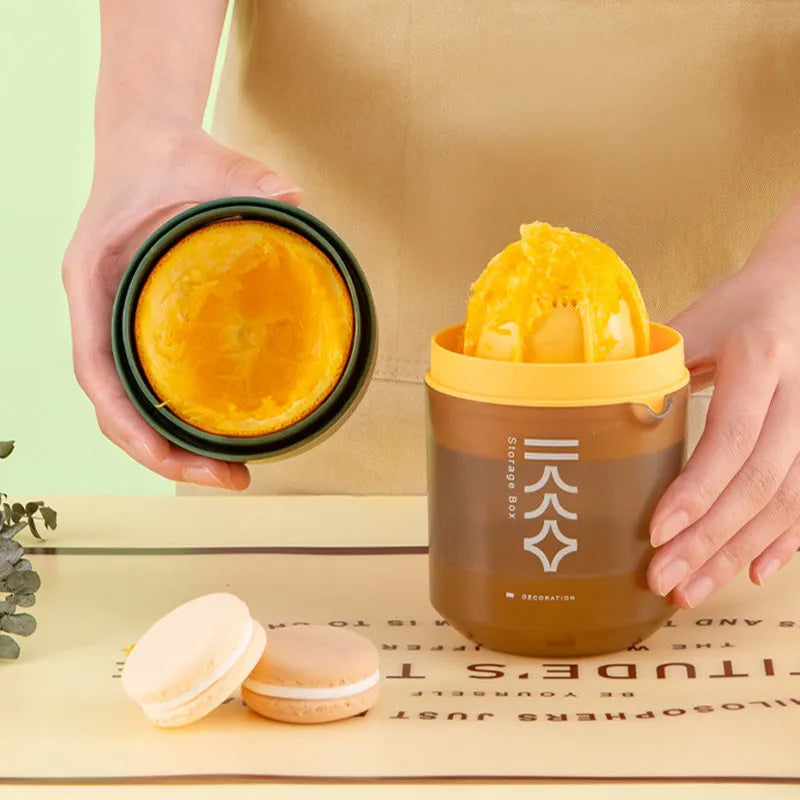 Green manual handheld citrus juicer with 400ml capacity on a kitchen counter