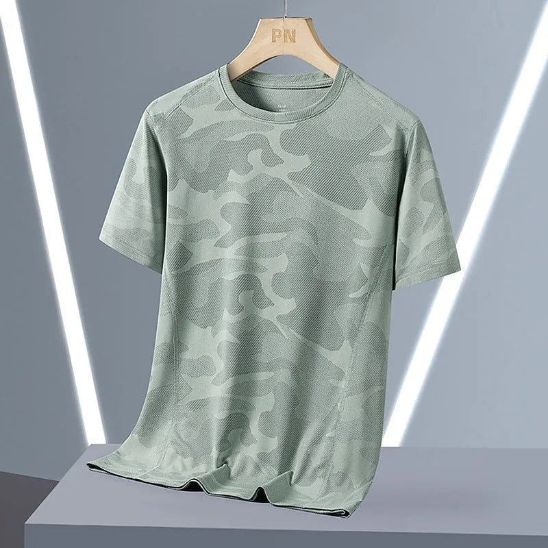 Plus size men's camouflage print short sleeve top in nylon fabric on a hanger.