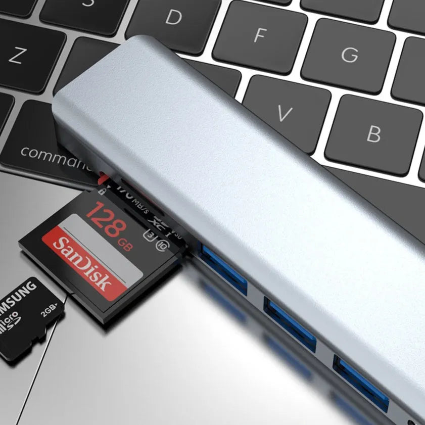 Seven-in-one USB C docking station expander hub with aluminium housing and multiple ports.