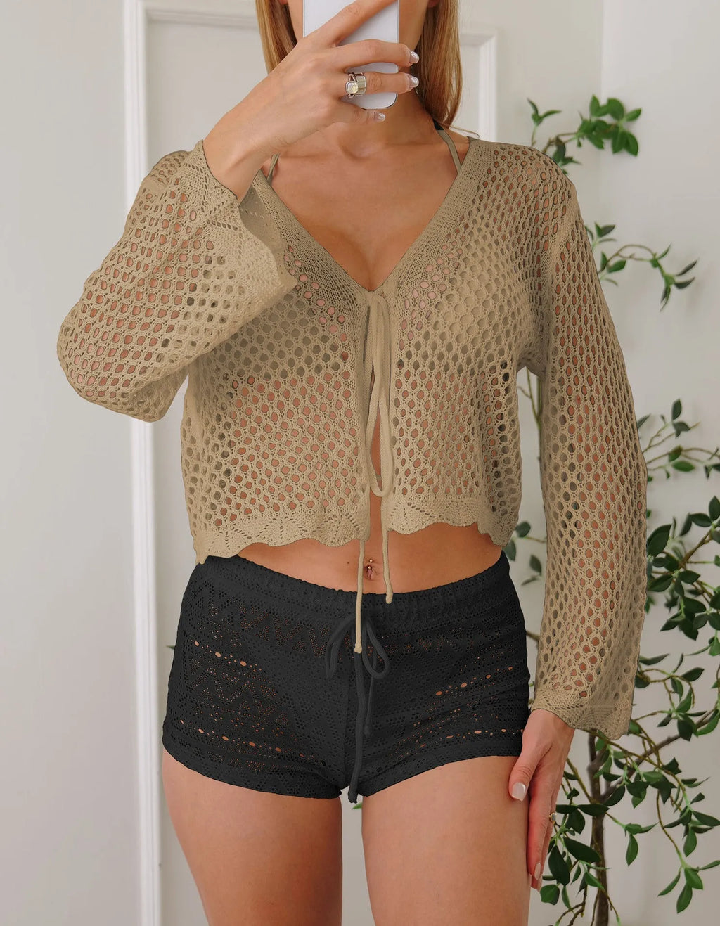 Short apricot coloured women's cardigan blouse with hollow weave texture and flared bell sleeves.