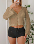 Short apricot coloured women's cardigan blouse with hollow weave texture and flared bell sleeves.