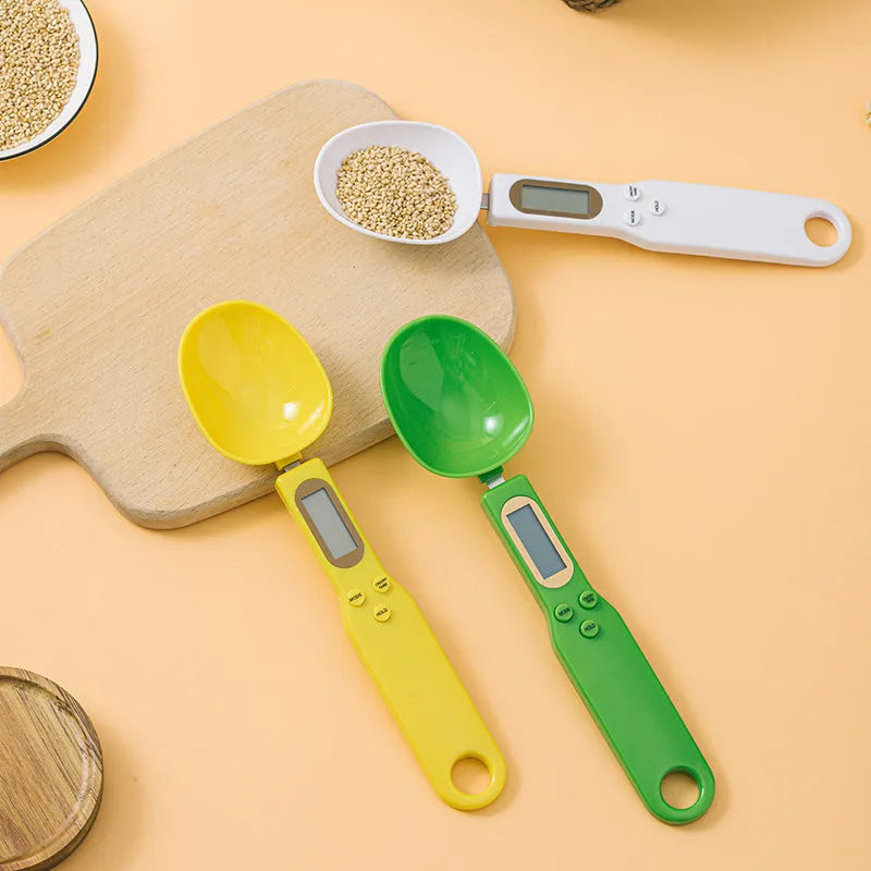 White digital kitchen scale with LCD display and spoon-shaped weighing surface for precise ingredient measurements
