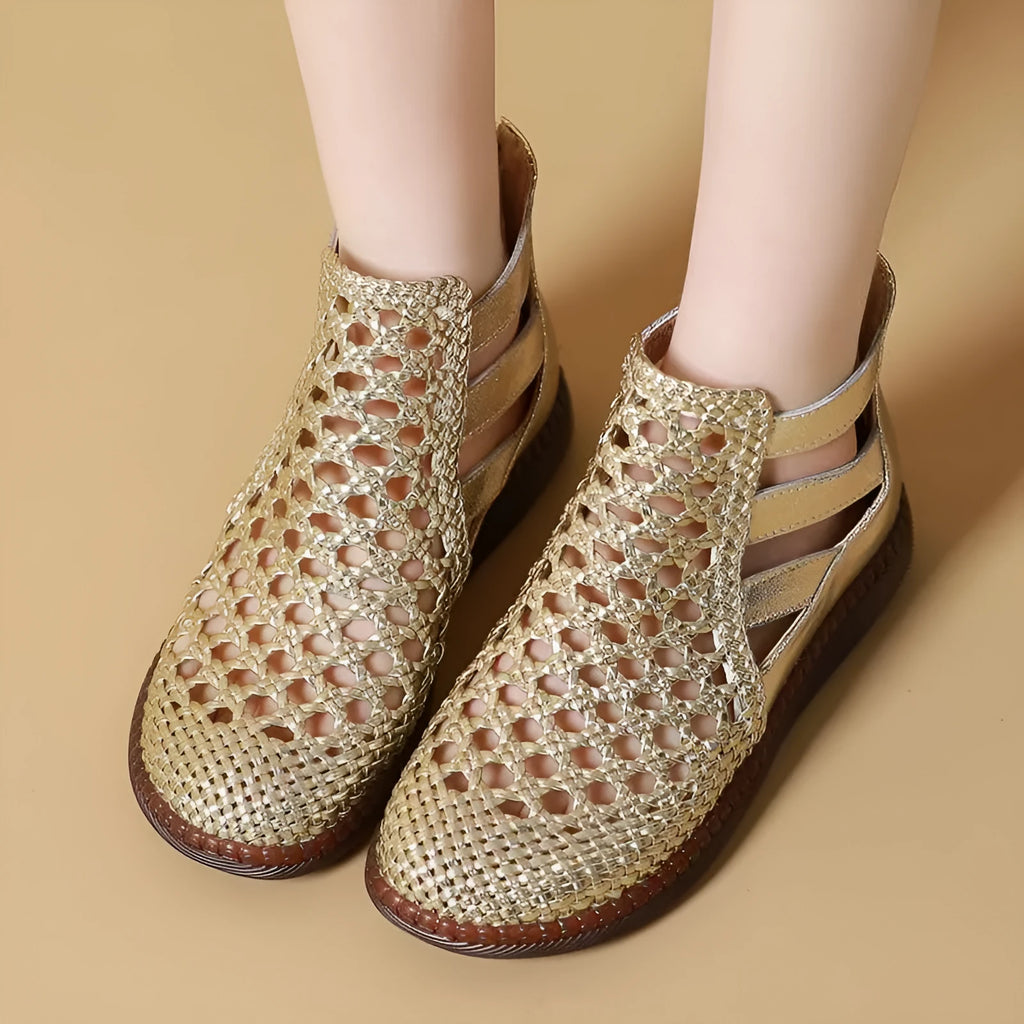 Women's flat sandals with hollow-out design and round toe in gold colour on white background
