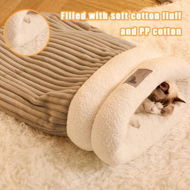 Brown semi-enclosed pet sleeping bag with plush lining on a wooden floor.
