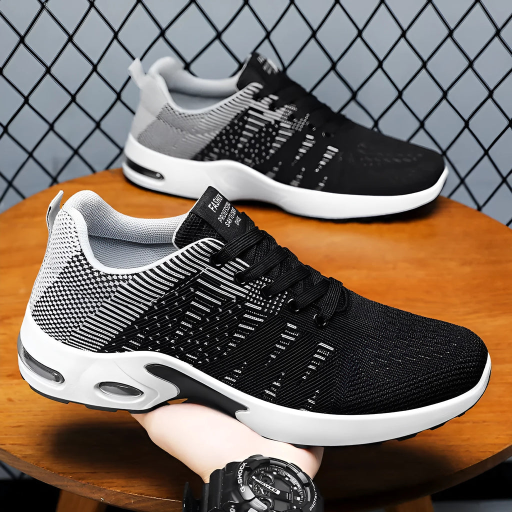 Men's Flyknit mesh low-top casual sneakers in black and grey colourway with lace-up front.