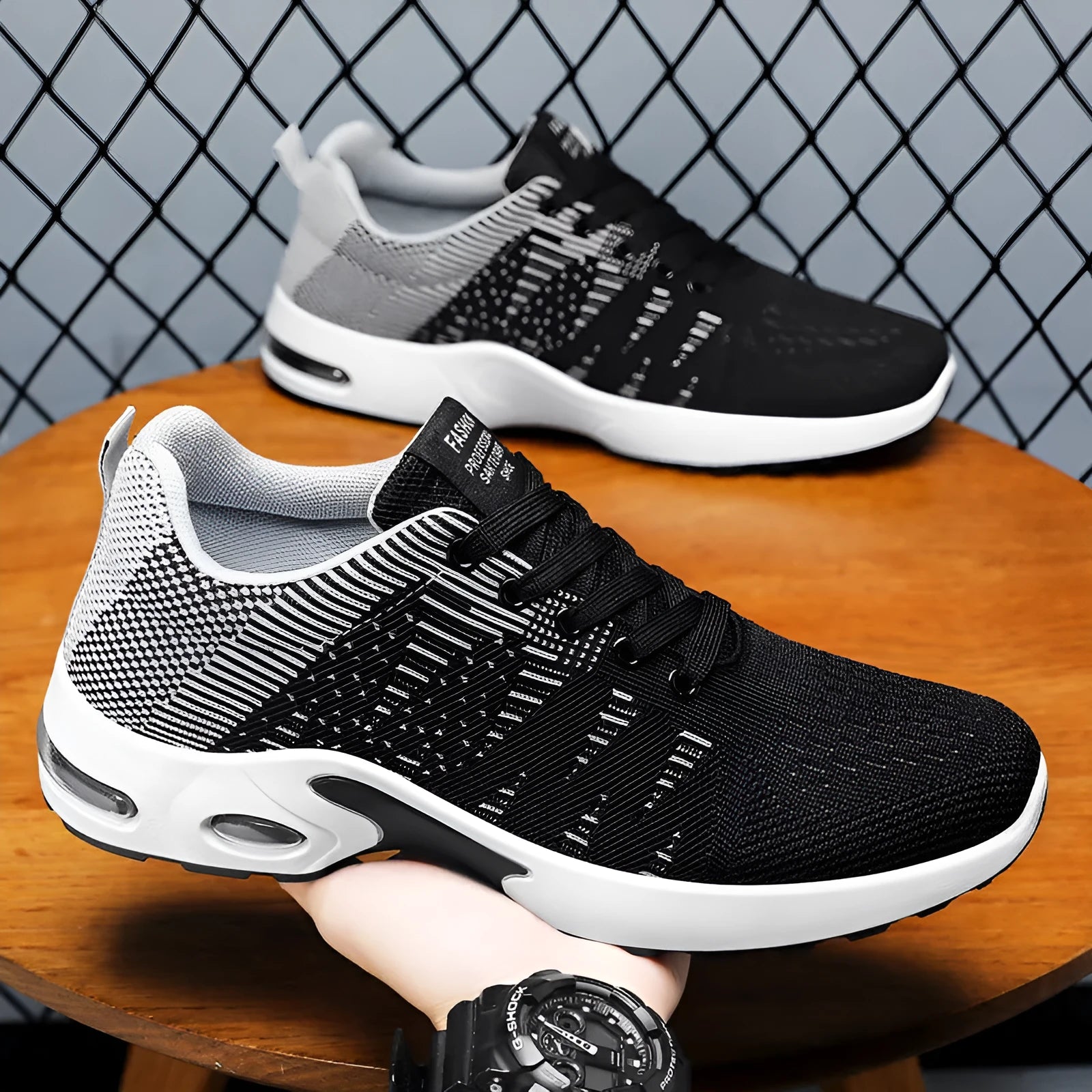 Men's Flyknit mesh low-top casual sneakers in black and grey colourway with lace-up front.