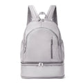 Women's casual backpack in grey colour showing curved shoulder straps and contrast stitching details