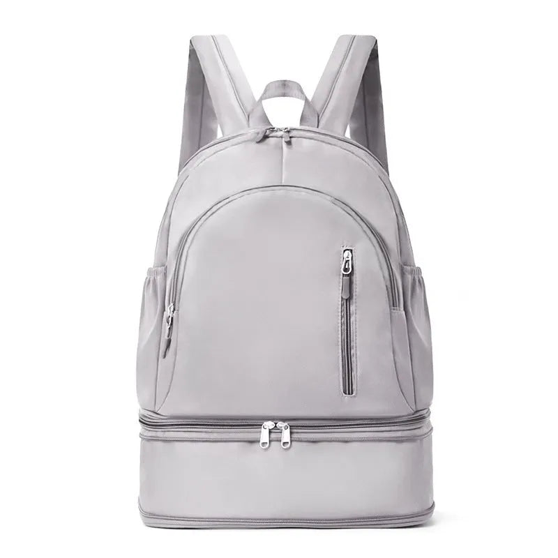 Women's casual backpack in grey colour showing curved shoulder straps and contrast stitching details