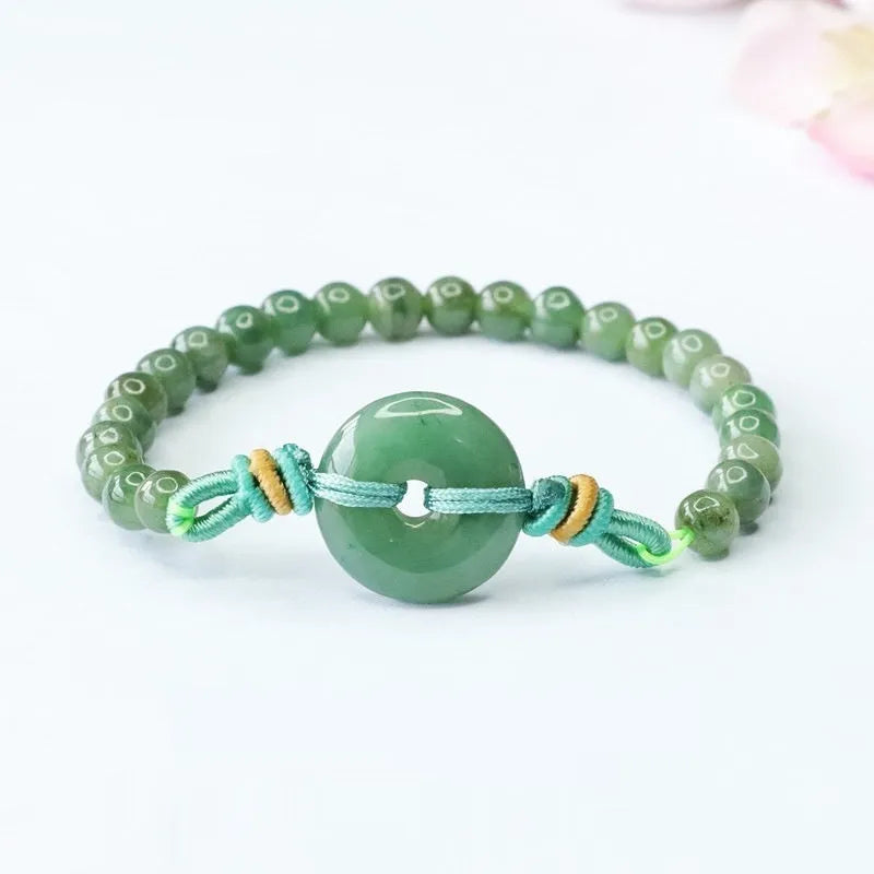 Emerald green jade bracelet with peace buckle clasp and star design elements