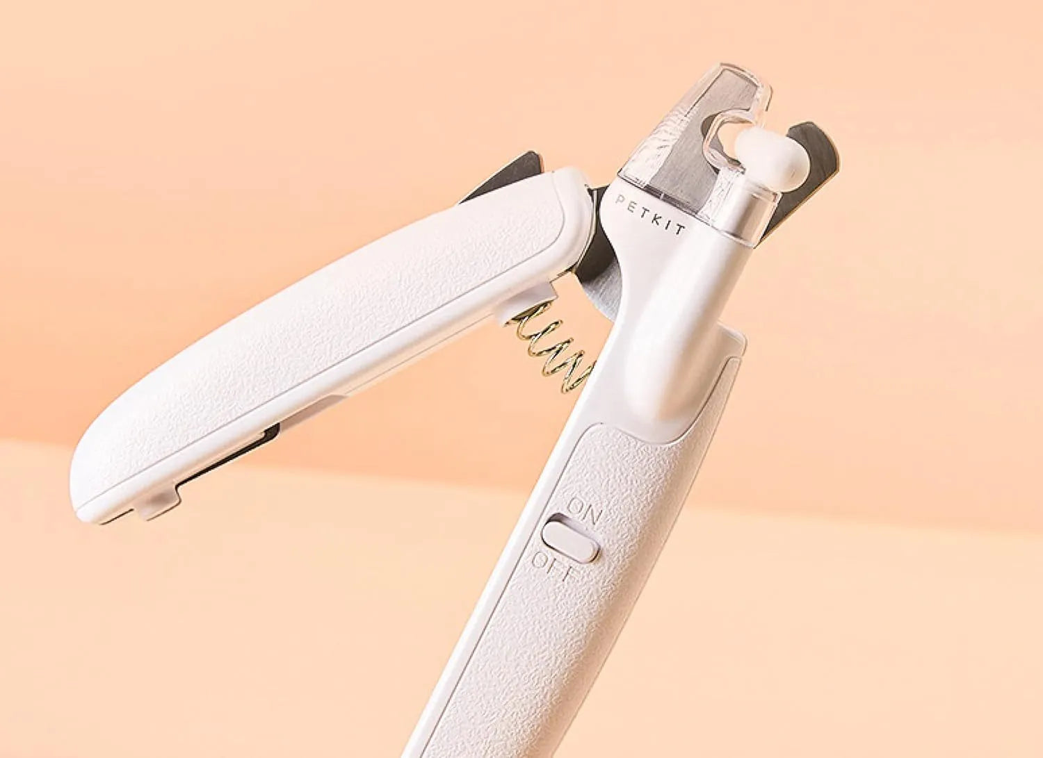 White pet nail clipper with LED light, transparent anti-splash guard, and leather-like handle