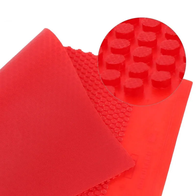 Single uncut sheet of black and red small particle table tennis rubber.