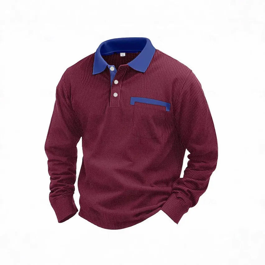 Man wearing a loose-fit dark grey waffle-texture long-sleeved polo shirt with an asymmetric style detail.