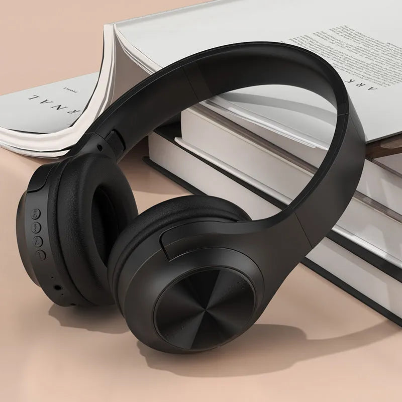 Creative head-mounted wireless Bluetooth headset in Ivory White colour on a charging bin.