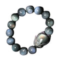 Obsidian stone bracelet with carved fox design in cartoon style, showing dark stone colouration