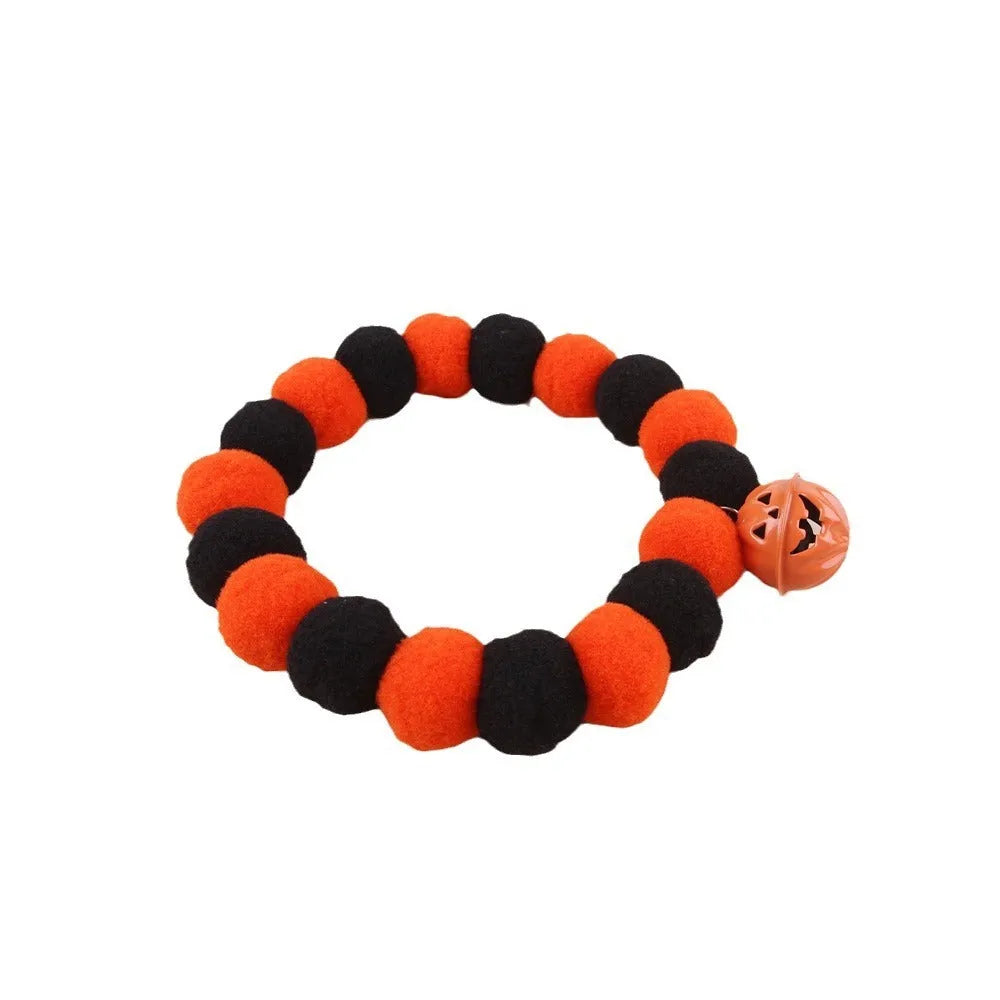 Adjustable orange plastic cat collar with a detailed Halloween pumpkin decoration.