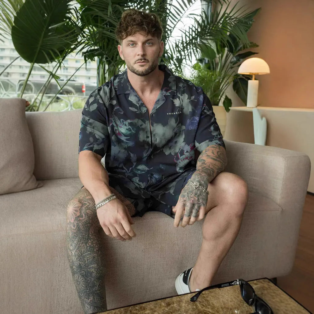 A loose-fitting short sleeve casual top with a floral print, shown in a light colour on a male model.
