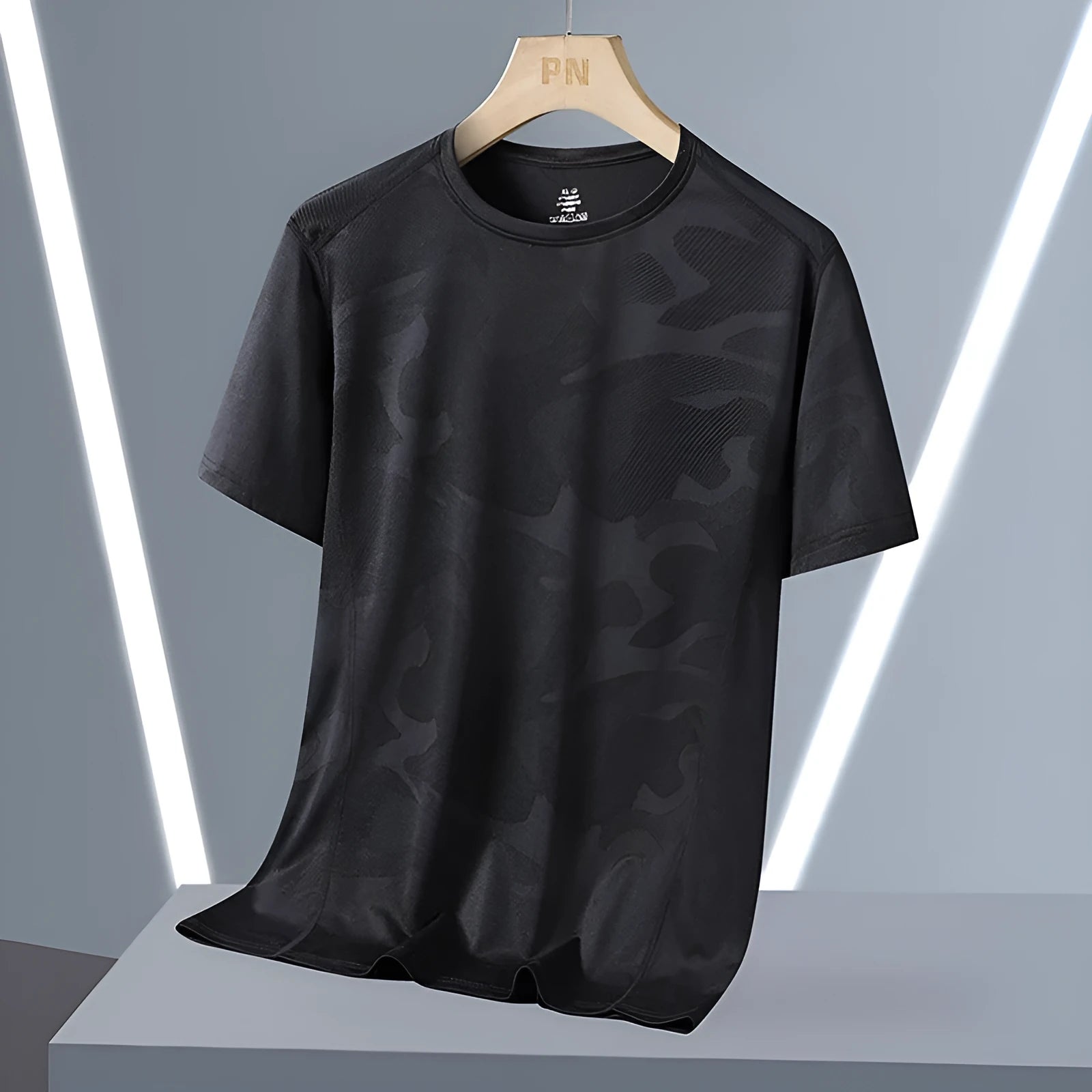 Plus size men's camouflage print short sleeve top in nylon fabric on a hanger.