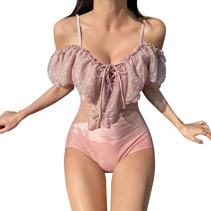 Solid pink women's one-piece nylon swimsuit laid flat.