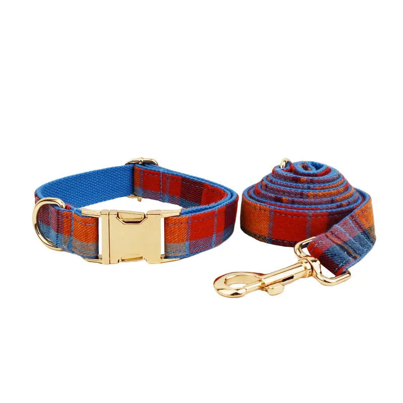 Blue plaid cloth dog collar with attached hand holding rope on adjustable size settings